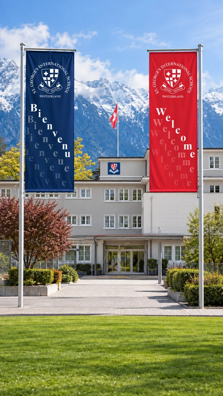Mise en situation : drapeaux Bienvenue et Welcome devant le bâtiment de l’école St. Georges à Montreux